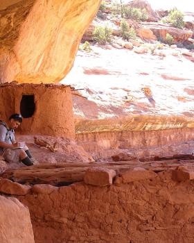 Jose Ochoa sketching at the Ancestral Puebloan cliff dwelling: Moon House, southeastern Utah.