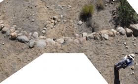 ALI Graduate Research Intern Lily Kerrigan surveys a pre-Columbian water control structure outside Safford, Arizona.